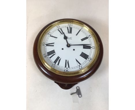 A Comitti Eight day bell strike movement. 10 inch dial with enamel finish and lacquered brass fittings W:33cm x D:13cm x H:37