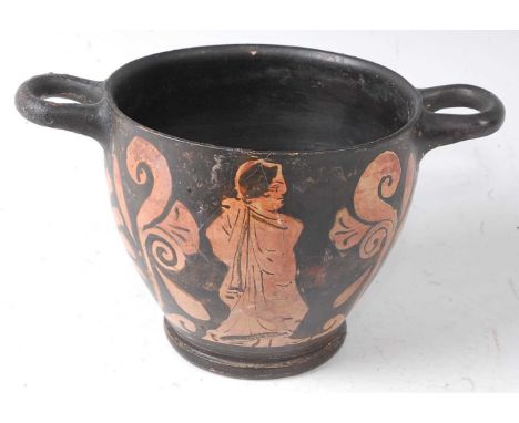 * A pottery skyphos, having typical twin handles, the black body decorated with a male figure with a female figure to the opp