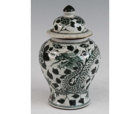 * A Chinese ceramic vase and cover, the domed cover underglaze decorated with a band of green flowers, the baluster body deco