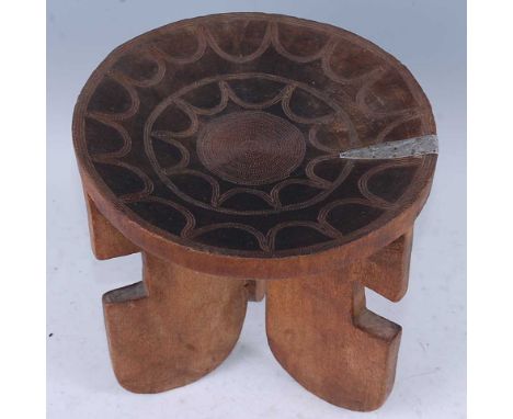 An African hardwood stool, the dished seat with concentric copper beading, raised on shaped tripod supports, probably Kamba P