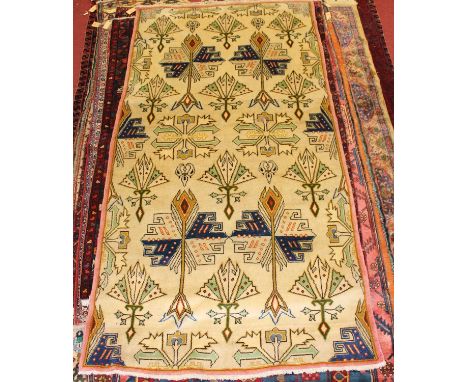 * A Caucasian woollen rug, the cream ground decorated with stylised motifs within a narrow pink border, 138 x 260cmCondition 