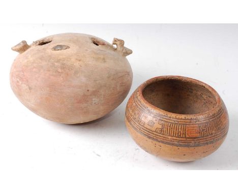 * A pottery stirrup vessel, of typical squat circular form, Northern Peru, pre-Columbian, circa 600 AD, h.14cm, together with