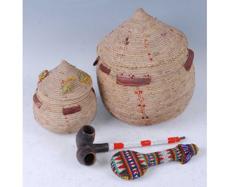 An African pipe, having two bowls to a single stem with applied red and white bead decoration, 24cm, together with a beadwork