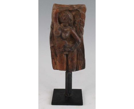 * A ceramic panel, relief decorated with a nude female with right arm aloft and leaf in hand, mounted on an iron stand, South