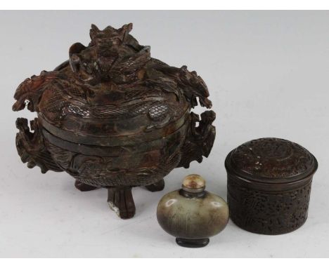 * A Chinese hardstone jar and cover of squat circular form, the cover carved with three dragons, the base with two dragons th