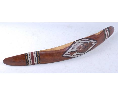 A Mulga wood (Acacia aneura) parrying shield, of curved form having bands of polychrome painted decoration, bearing a label "