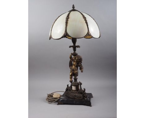 A bronzed table lamp with cherub support and Tiffany style shade, 28" high 