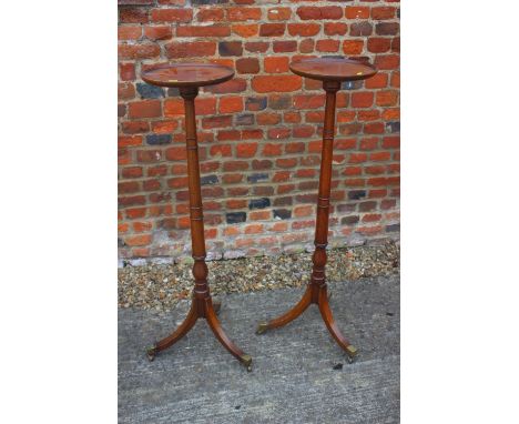 A pair of mahogany torcheres with faux bamboo turned columns, on tripod splay supports with brass terminals, 11" dia x 42" hi