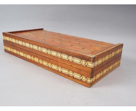 A polished as walnut and inlaid backgammon board with composition pieces, 19" wide, a plated tray, a pair of sugar cutters an