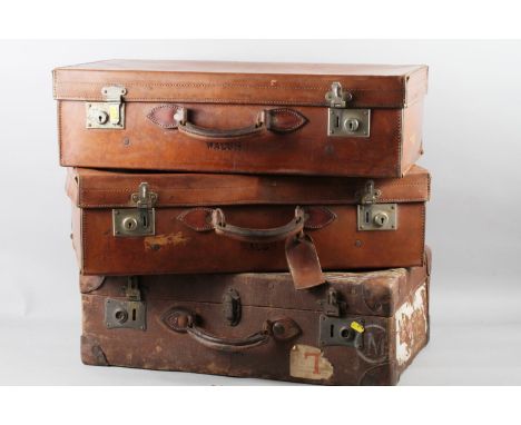 A pair of early 20th century leather bound suitcases, stamped "Walsh", 26" wide, and a "Pukka Luggage" canvas and leather bou