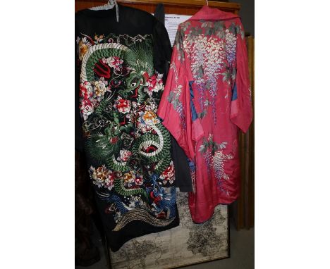 A mid 20th century wisteria embroidered kimono on a pink ground and a similar kimono with dragon embroidery on a black ground