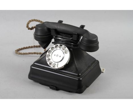 A black cased rotary telephone, No 1/232 