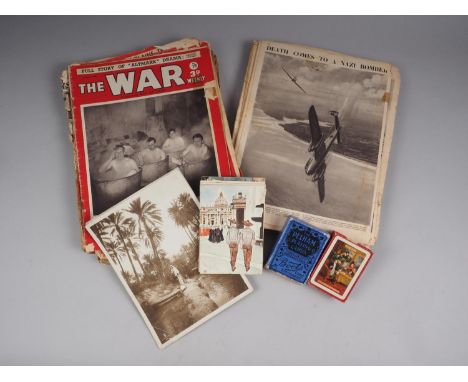 A quantity of "The War" magazines, assorted postcards, two decks of playing cards and topographical photographs 