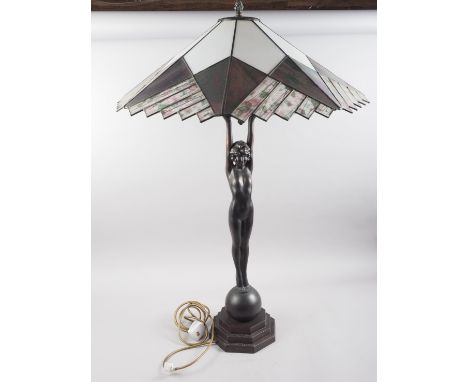 An Art Deco design bronzed table lamp, formed as a girl holding a lamp aloft, with leaded glass shade, 36" high 