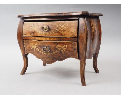 A miniature polished and grained as walnut inlaid Continental two-drawer commode with swag decoration, 11" wide