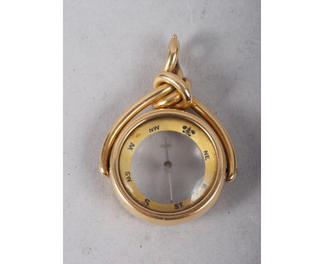 An 18ct gold fob swivel inset compass, 14.5g grossSmall knocks/dents to bezell of comapss 