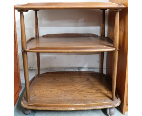 A mid 20th century elm and beech Ercol three tier tea trolley, 77cm high x 71cm wide x 46cm deep Condition Report:Available u