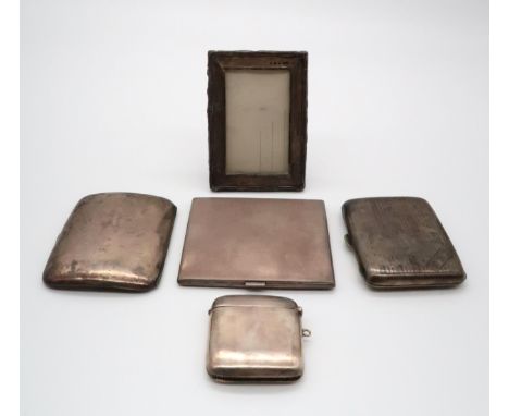A collection of silver including a small rectangular silver photo frame, by Green &amp; Cradbury Ltd, Birmingham 1923, a silv