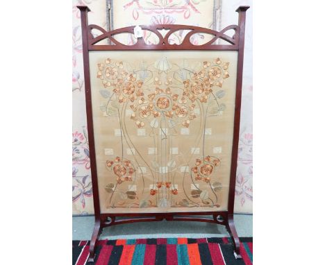 An early 20th century Art Nouveau mahogany framed fire screen with embroidered silk panel, 109cm high x 71cm wide x 29cm deep