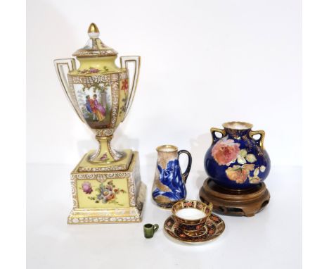 A miniature Dunmore tankard, 1cm high, a miniature Royal Crown Derby cup and saucer, miniature Doulton ewer and vase, togethe