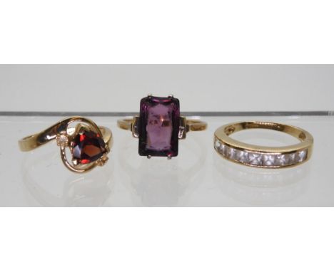 A gems TV trilliant cut&nbsp;garnet and citrine ring, size O, a 9ct clear gem set eternity ring size N1/2, and a yellow metal