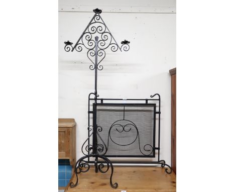 An early 20th century wrought iron Art Nouveau style fire screen and a 20th century Gothic revival light standard (2) Conditi