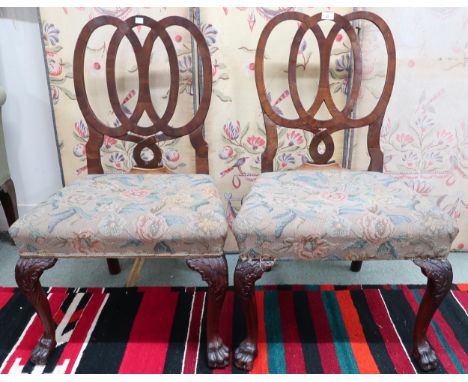 A pair of 19th century walnut framed dining chairs with shaped pierced splats over tapestry upholstered seats on cabriole sup