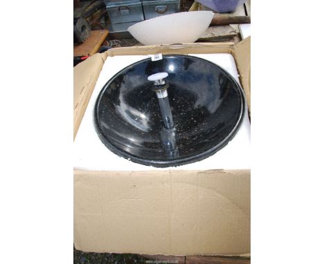 A circular granite basin - 17" diameter.