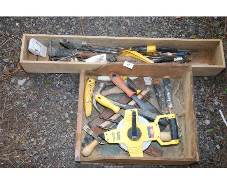 A quantity of tools and large measuring tape.