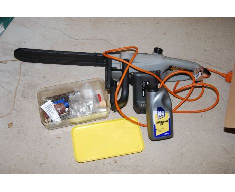 A 'Titan' electric chainsaw with sharpening equipment and oil.