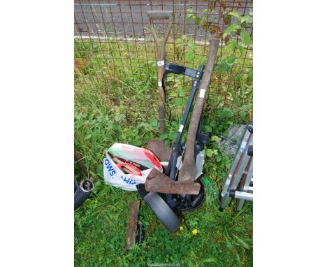 A golf trolley, spade, axe and a bag of tools.