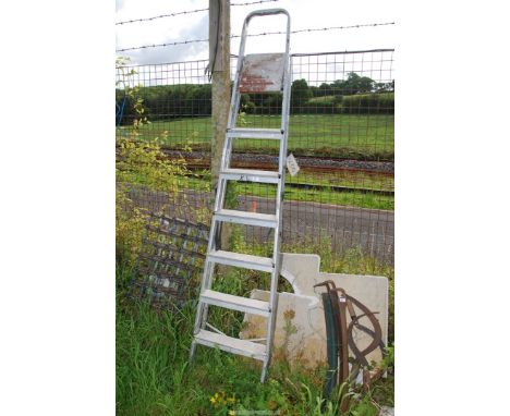 A seven rung aluminum step ladder.