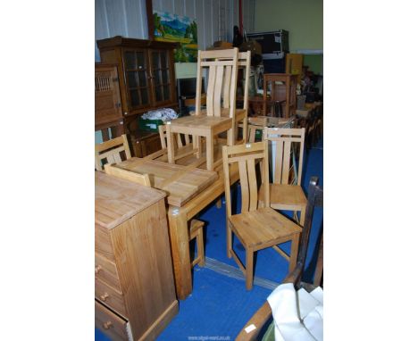 Eight light oak dining chairs.