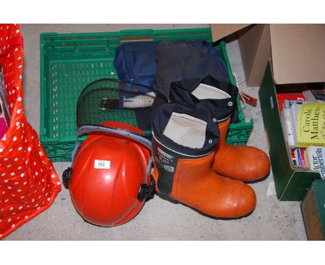 A box containing Oregon chainsaw boots, Size:8, Husqvarna safety helmet, and trousers.