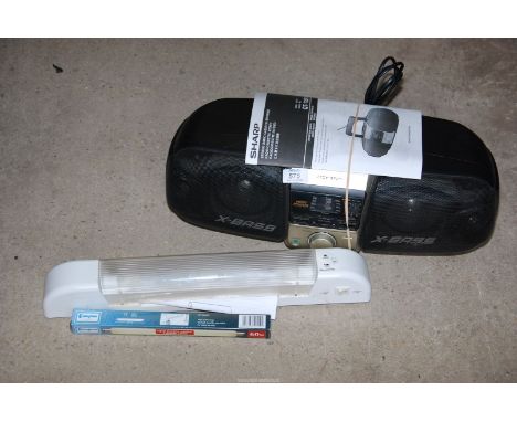 A bathroom light, a 'Sharp' stereo cassette recorder.