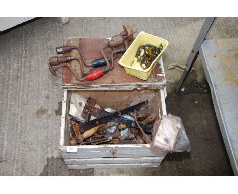 A wooden toolbox containing brace, bit drills, and old door locks.