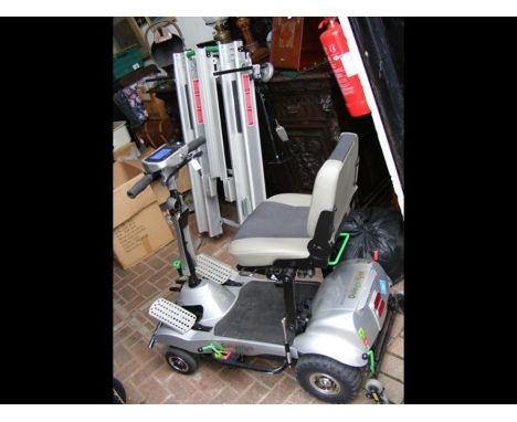 A Quingo Flyte mobility scooter, together with remote controlled in-car ramp/docking station