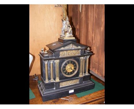 A 60cm high Victorian slate and metal mounted mantel clock by Wattis of Birmingham