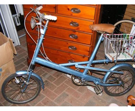 A vintage lady's bike with basket on back 