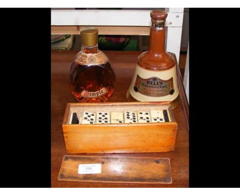 A cased set of old dominoes, Dimple Scotch whiskey, together with one other