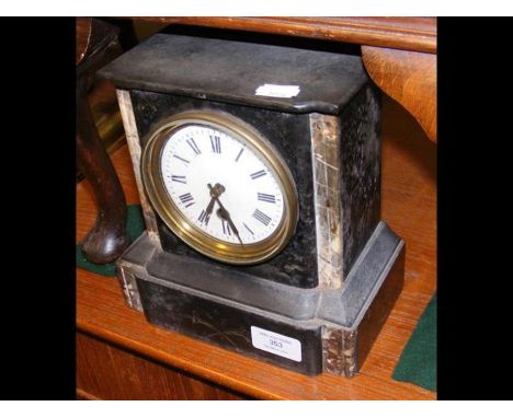 A small slate and marble mantel clock 