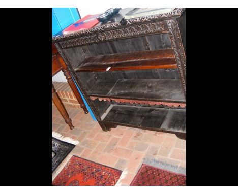 A Victorian carved oak open book shelf