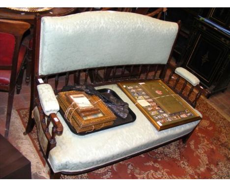 An Edwardian settee in light green floral material