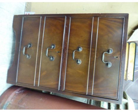 A modern mahogany pedestal filing cabinet, the top with a tooled green hide scriber, over two drawers, raised on bracket feet