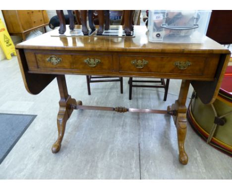 A modern crossbanded walnut sofa table with two frieze drawers and a pair of facsimiles on the reverse, raised on splayed leg