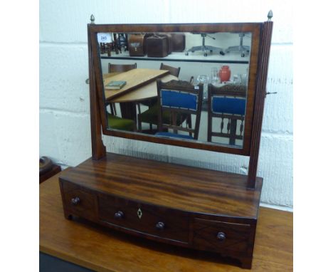 A late Victorian ebony inlaid mahogany dressing table mirror, the rectangular plate on tapered, pivoting horns, elevated on a