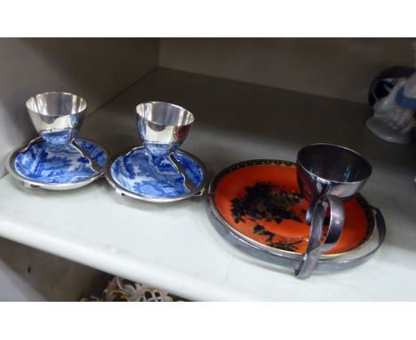 A Crown Staffordshire pottery saucer, set in a Hukin & Heath silver plated frame, incorporating an egg cup; and a pair of Cop