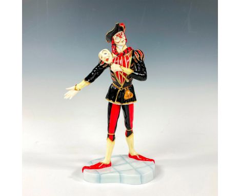 Figural is part of the Prestige Carnival Collection, dressed in red, black, and gold holding a white mask on a gilded brass s