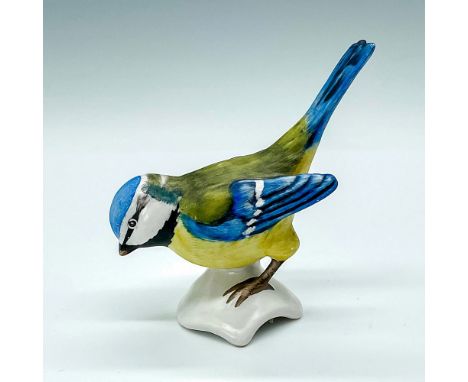 Figurine depicting a bird crouched down, hand painted with blue and yellow. W.Goebel sticker and backstamp. Issued: 1972 to 1