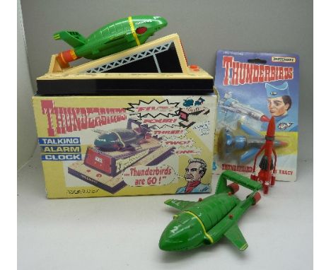Three Thunderbirds toy vehicles and a Thunderbirds talking alarm clock, boxed